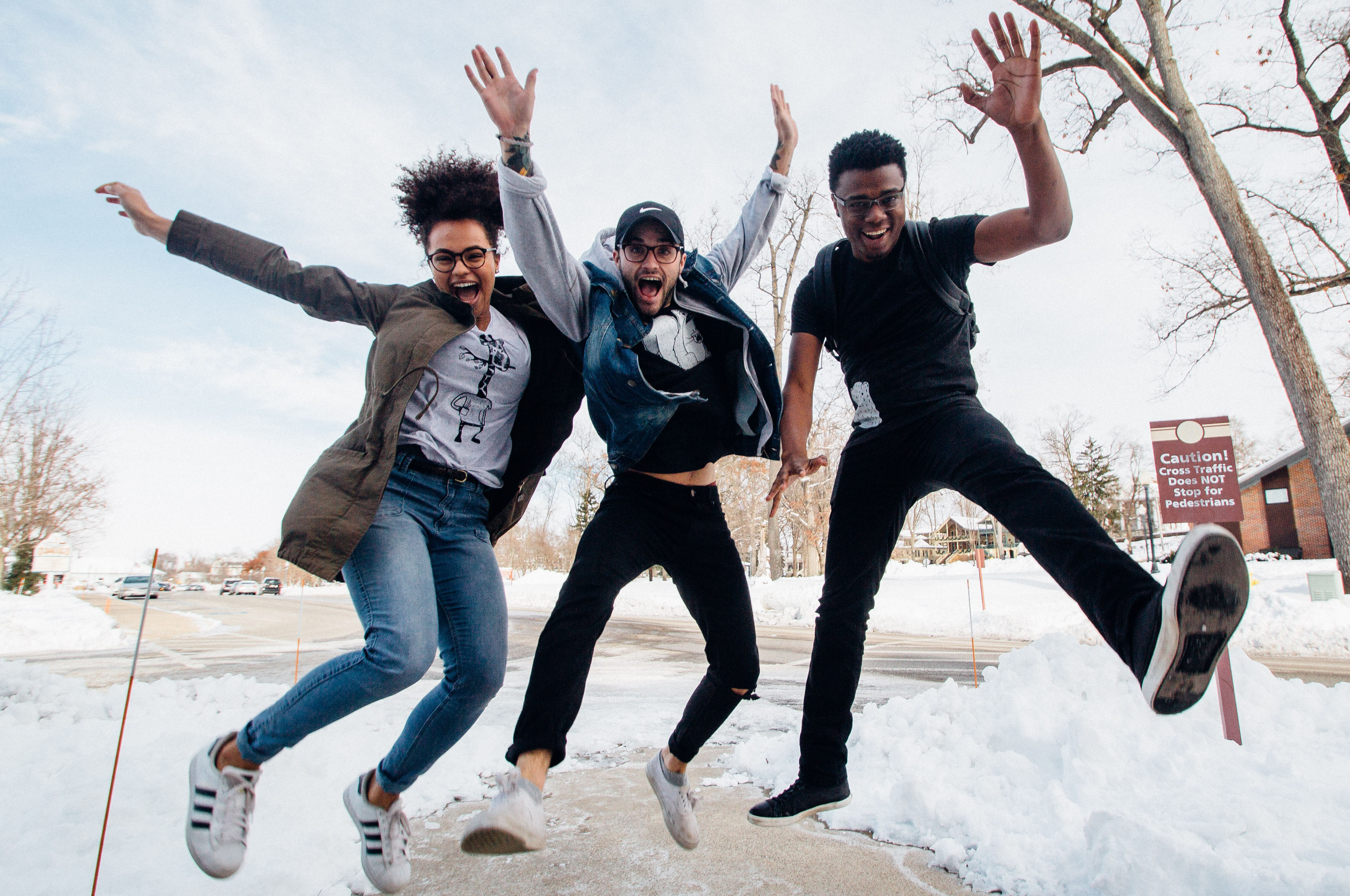 Image of happy multicultural students jumping